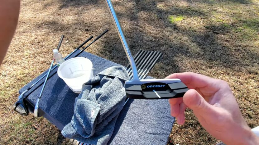 golfer cleaning his golf club