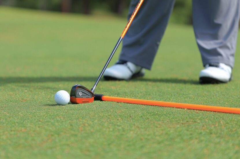 Swing drill using alignment stick to fix a slice